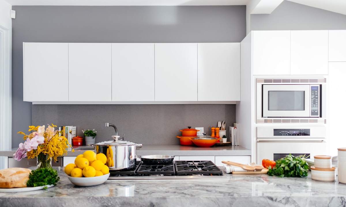 Modern kitchen with clean countertops and appliances — SamplePkg: Harbor View — 2BR corner unit